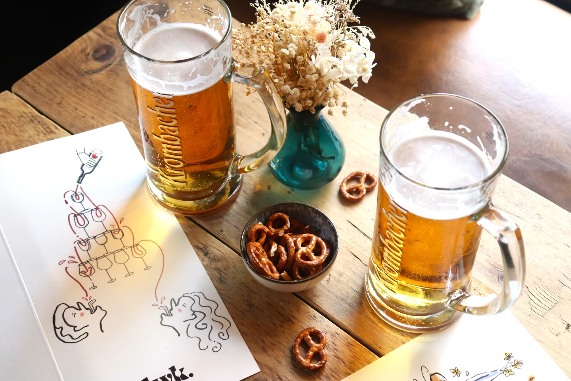 Two glasses of beer, pretzels and dried flowers on the table at Leith Wine Kitchen