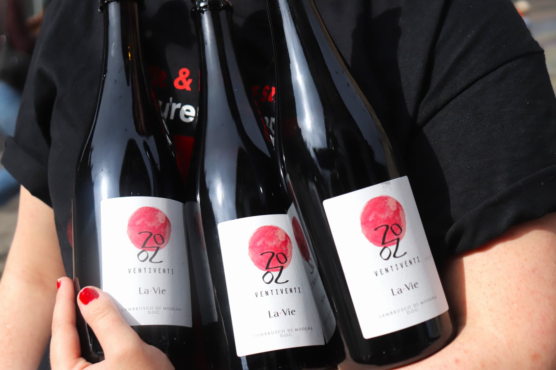 Two bottles of rosé wine raised in a toast