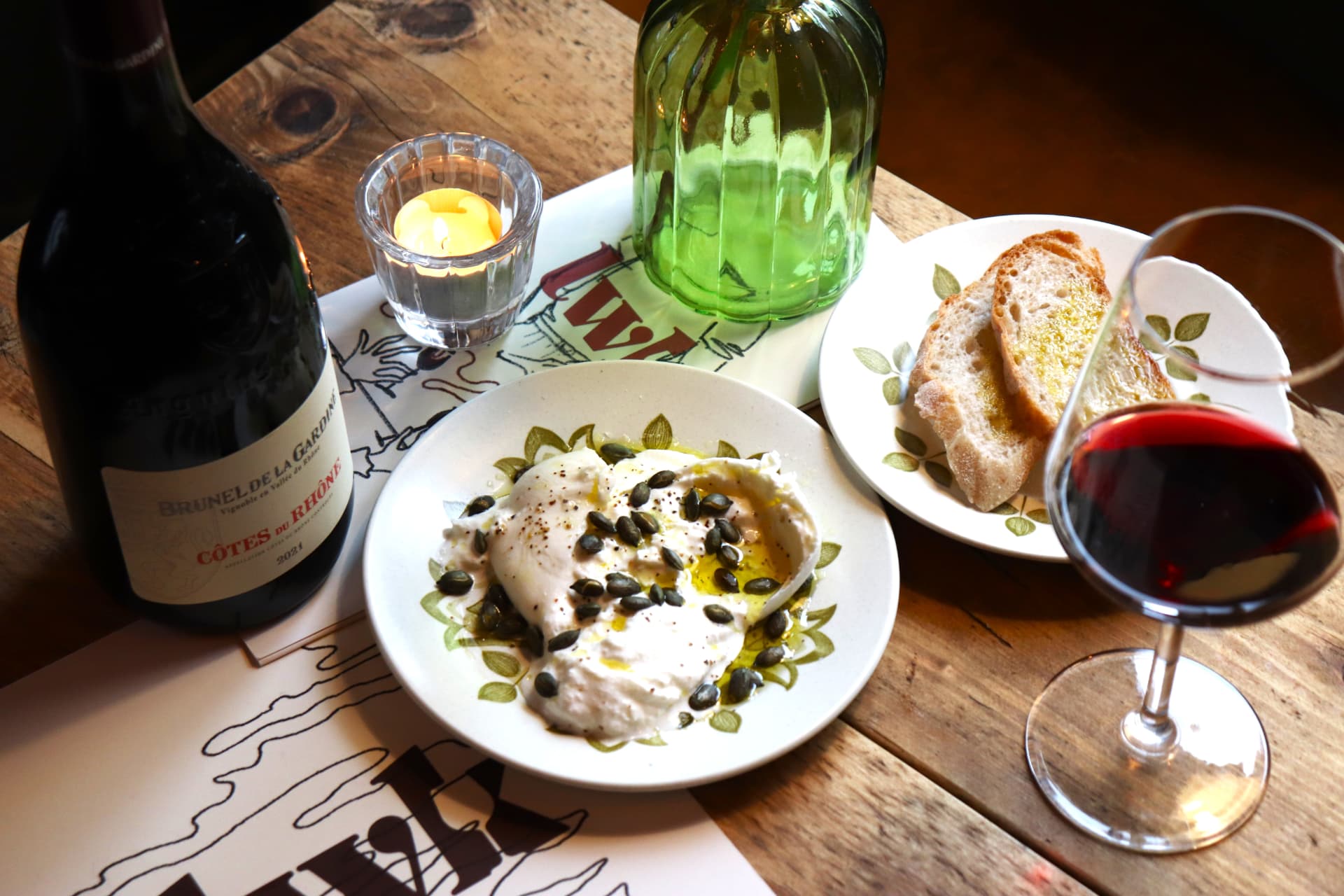 Red wine, bread and a plate at Leith Wine Kitchen